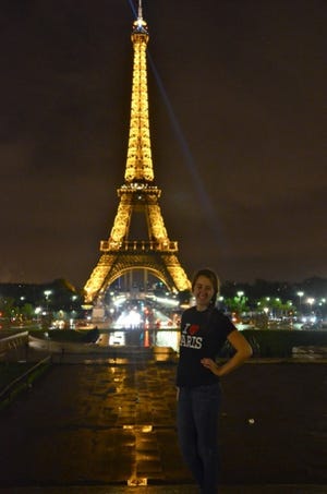 Elizabeth enjoys the Eiffel Tower at night.