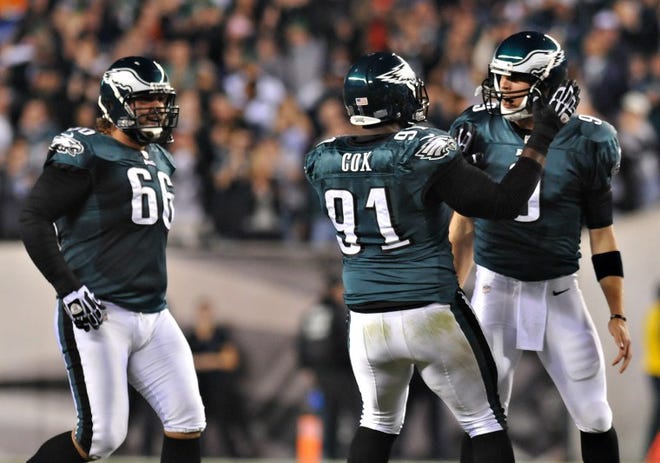 Eagles quarterback Nick Foles, right, celebrates his first NFL touchdown pass with Fletcher Cox in the third quarter of Sunday's game against the Dallas Cowboys at Lincoln Financial Field in Philadelphia.