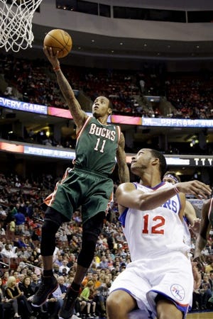 The Bucks' Monta Ellis (11) drives past the Sixers' Evan Turner (12) during Monday's game at the Wells Fargo Center.