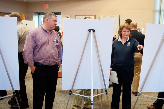 Missouri Department of Transportation Area Engineer Michael Schupp, left, listens to a question about roundabouts from Battle High School Principal Kim Presko, right, during an open house about proposed Route Z improvements at the Boone County Government Center Wednesday.