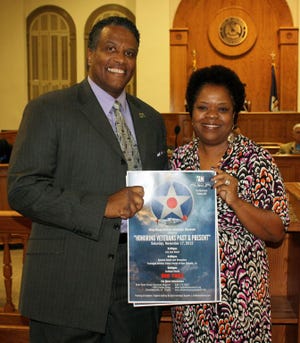 Kathe Hambrick (right), director of the River Road African American Museum, is shown holding a poster announcing the upcoming “Honoring Veterans Past and Present” program to be held on Saturday, Nov. 17 in Donaldsonville. Hambrick is shown with Ascension Parish Chief Executive Assistant Ken Dawson.