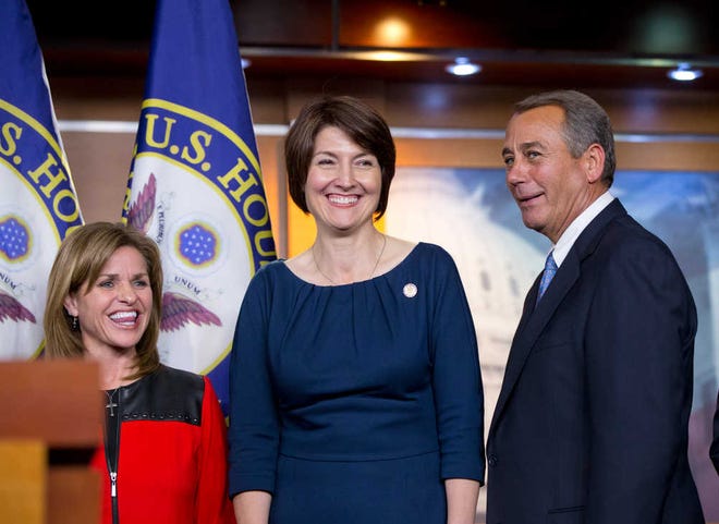 Speaker of the House John Boehner, R-Ohio, stands with Rep. Cathy McMorris Rodgers, R-Wash., center, and Rep. Lynn Jenkins, R-Kan., after the House GOP voted for their leadership for the next session of Congress, at the Capitol in Washington on Wednesday.