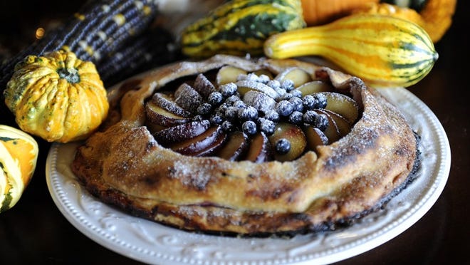 Fall harvest crostata with plums, pears and blue berries.