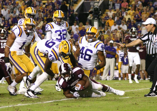 LSU’s Eric Reid, Craig Loston, Barkevious Mingo, Jalen Collins and Kevin Minter converge on Mississippi State’s Josh Robinson for no gain in the second quarter of the Tigers’ 37-17 victory in Death Valley on Saturday night. 
POST SOUTH PHOTO/Peter Silas Pasqua