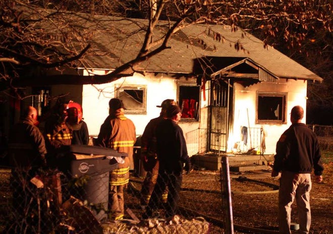 Topeka fire crews early Thursday survey a house at 801 S.E. Highland that was destroyed by an early-morning fire. The cause of the blaze was under investigation.