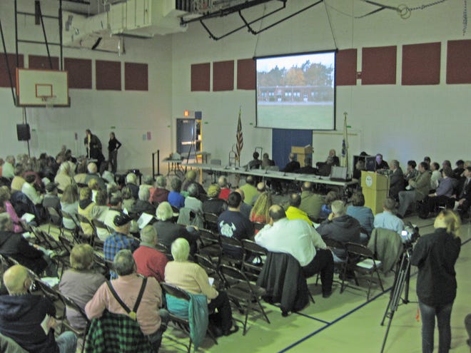 Voters watch a video presentation on the new Town Hall at the Berkley special Town Meeting on Wednesday. The $3.5 million, 10,000 square-foot Town Hall was approved, 186-36.