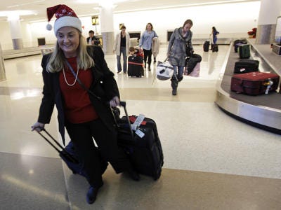 In this Dec. 21, 2010 file photo, holiday travelers collect
their luggage at the San Jose International Airport in San Jose,
Calif. (AP Photo/Marcio Jose Sanchez, File)