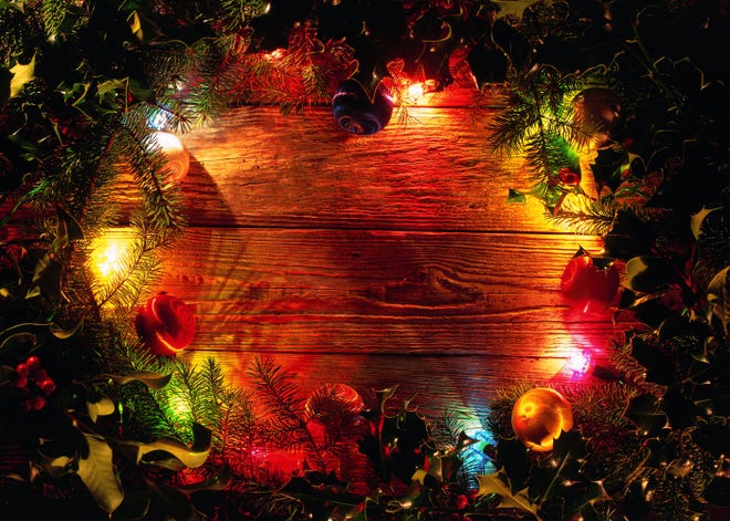 close-up of a patch of wood seen through the center of a Christmas wreath