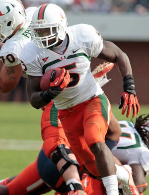 Miami running back Mike James (5) runst the ball during the second half of an NCAA college football game in Charlottesville, Va., Saturday, Nov. 10, 2012. Virginia won the game 41-40. (AP Photo/Steve Helber)