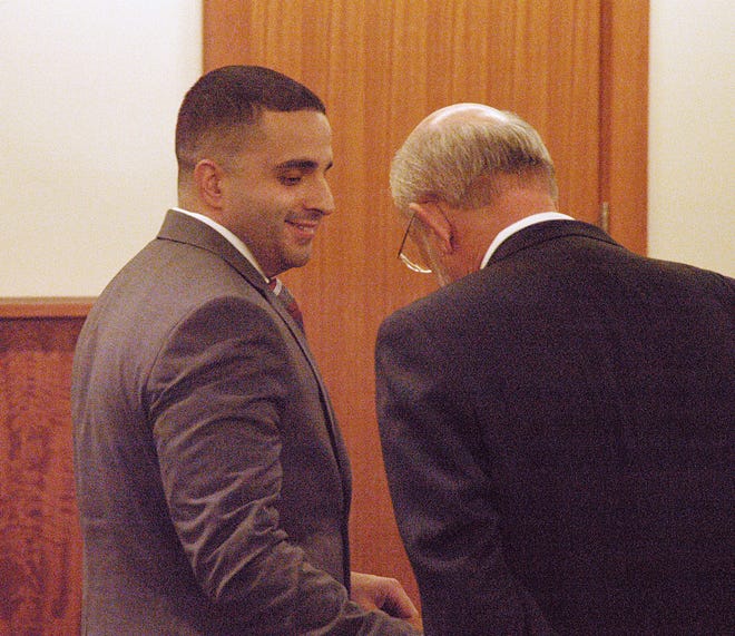 Nelson Melo, left, exchanges words on Thursday with his lawyer, Jack Atwood, as word came that the jury in Melo's murder trial had not yet reached a verdict.