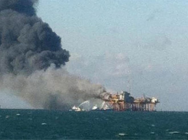 In this image released by an oil field worker and obtained by The Associated Press, a fire burns on a Gulf oil platform Friday after an explosion on the rig, in the Gulf of Mexico off the Louisiana coast. An explosion and fire ripped through a Gulf oil platform Friday as workers used a cutting torch, sending at least four people to a hospital with burns and leaving two missing in waters off Louisiana.