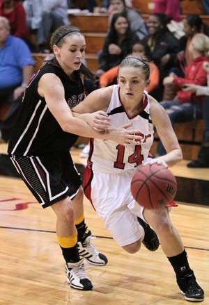 Belmont Abbey's Morgan Midkiff dribbles around Erskine's Tara Potter during the game on Saturday November 17, 2012 in Belmont.