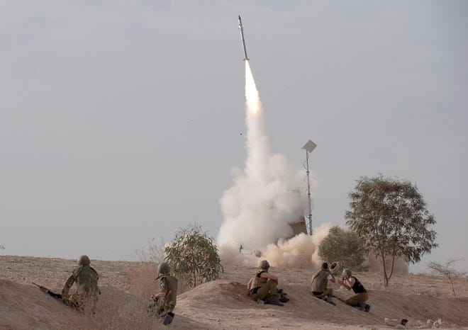 An Israeli Iron Dome missile is launched near the city of Be'er Sheva, southern Israel, to intercept a rocket fired from Gaza Saturday, Nov. 17, 2012. Israel bombarded the Hamas-ruled Gaza Strip with nearly 200 airstrikes early Saturday, the military said, widening a blistering assault on Gaza rocket operations to include the prime minister's headquarters, a police compound and a vast network of smuggling tunnels. (AP Photo/Ahikam Seri)