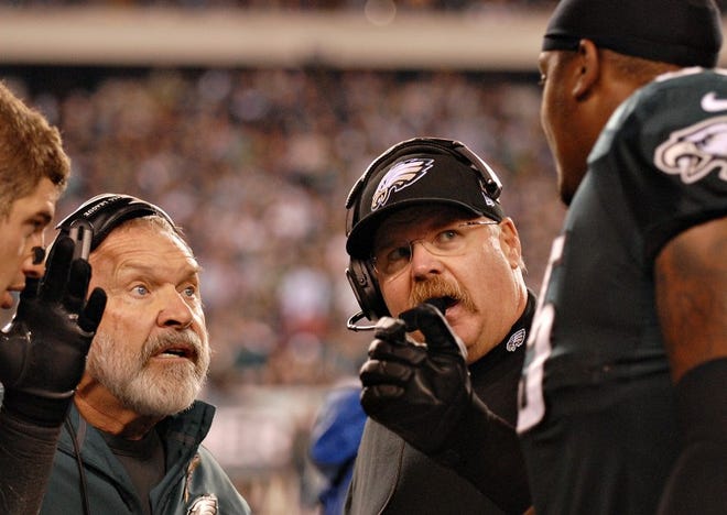 Eagles offensive line coach Howard Mudd, left, and head coach Andy Reid speak on the sidelines with lineman King Dunlap during the third quarte of Sunday's game against the Dallas Cowboys at Lincoln Financial Field in Philadelphia.