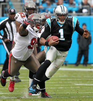 Panther QB Cam Newton tries to evade the Bucs on a run during Sunday's game.