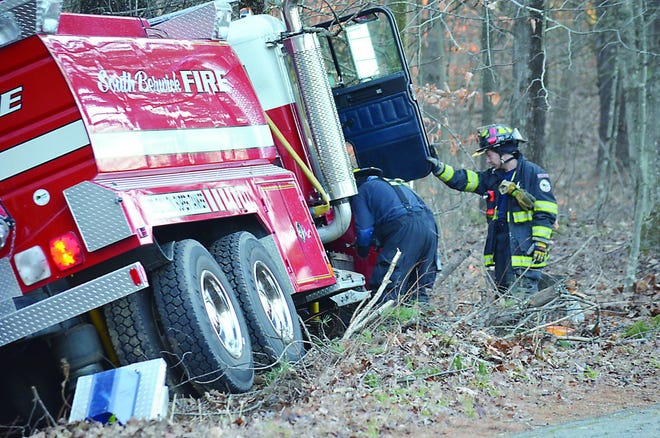 South Berwick Fire Department personnel investigate the scene where a tanker truck crashed into the woods near 42 Fife’s Lane.