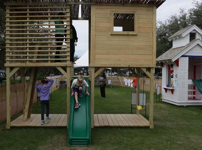 Children and parents play in a playhouse during the Cottages for Kids event hosted by the Children’s Volunteer Health Network, Inc. in Rosemary Beach, Fla. on Sunday, November 18, 2012.