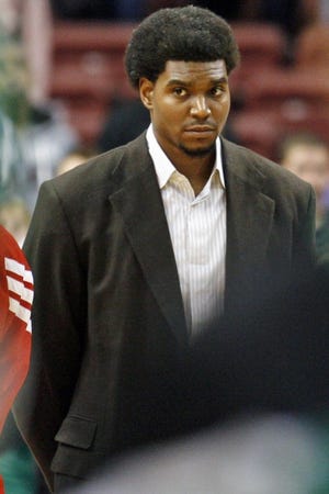 The Sixers' Andrew Bynum stands on the court and watches his teammates prior to an NBA preseason game.