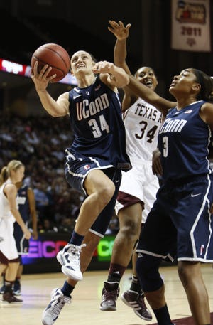 Connecticut's Kelly Faris (34) shoots the ball against Texas A&M defender Karla Gilbert (34) during the second half of an NCAA college basketball game on Sunday, Nov. 18, 2012, in College Station, Texas. Connecticut won 81-50.