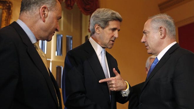 Sen. John Kerry, D-Mass., center, talks Tuesday with Israeli Prime Minister Benjamin Netanyahu on Capitol Hill as Sen. Charles Schumer, D-N.Y., stands by.