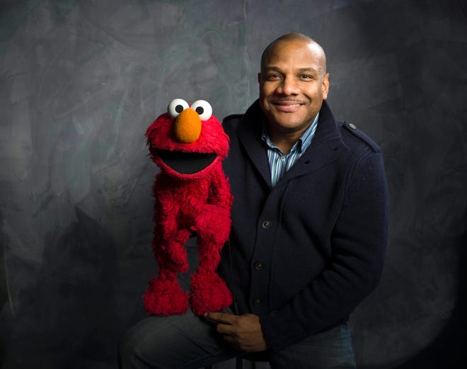 In this Jan. 24, 2011 file photo, Elmo puppeteer Kevin Clash poses with the "Sesame Street" muppet in the Fender Music Lodge during the 2011 Sundance Film Festival in Park City, Utah. The man who accused Clash of having sex with him when he was a teen now says it isn't so. The man said in a statement released on Tuesday, Nov. 13, 2012 that his sexual relationship with Clash was adult and consensual. (AP Photo/Victoria Will, File)