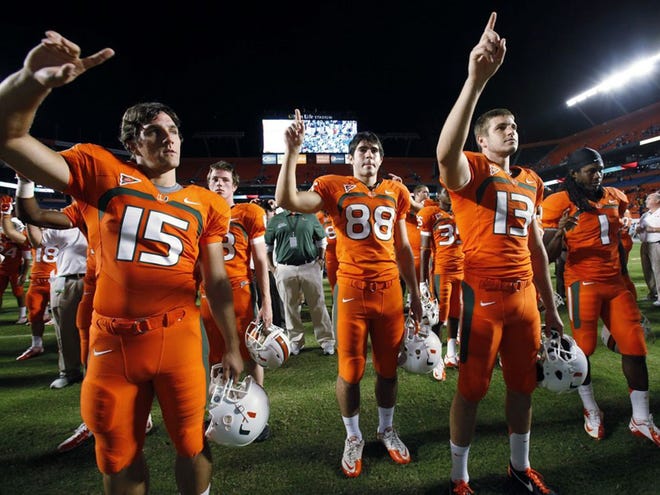 Miami players sing their alma mater as they celebrate their 40-9 win over South Florida in an NCCA college football game, Saturday, Nov. 17, 2012 in Miami.