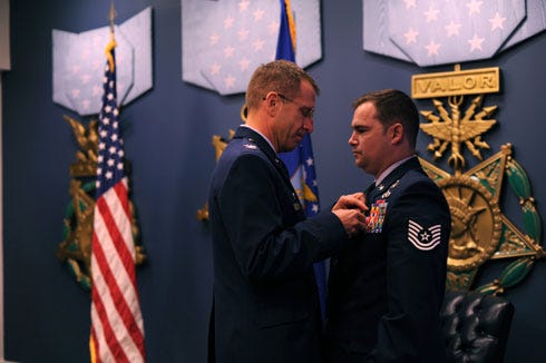 Col. Jim Slife, commander 1st Special Operations Wing, pins a Silver Star on Tech. Sgt. Joseph Deslauriers, an explosive ordnance disposal technician from the 1st Special Operations Civil Engineer Squadron, during a ceremony at the Pentagon, Nov. 14. Deslauriers earned the medal for gallantry in action while serving in Afghanistan Sept. 23, 2012.
