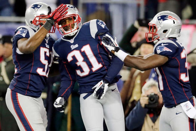 New England Patriots cornerback Aqib Talib (31) is congratulated by outside linebacker Jerod Mayo, left, and cornerback Alfonzo Dennard, right, after his interception that he ran back for a touchdown against the Indianapolis Colts in the second quarter of an NFL football game at Gillette Stadium in Foxborough, Mass., Sunday, Nov. 18, 2012. (AP Photo/Charles Krupa)