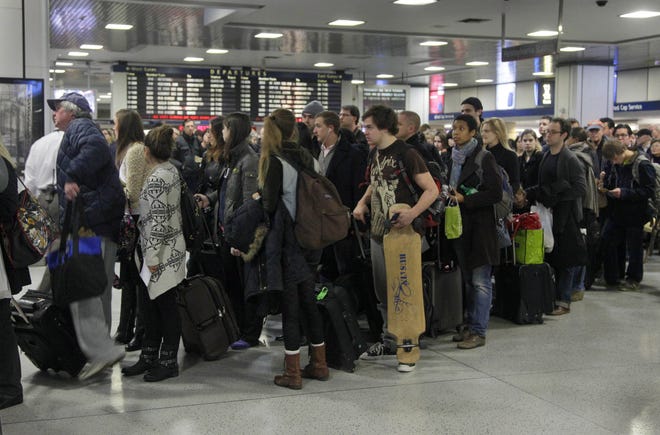 Passengers wait to board a train in New York's Penn Station, Wednesday, Nov. 21, 2012. Around 43.6 million Americans were expected to journey 50 miles or more between Wednesday and Sunday, just a 0.7 percent increase from last year, according to AAA's yearly Thanksgiving travel analysis. (AP Photo/Richard Drew)