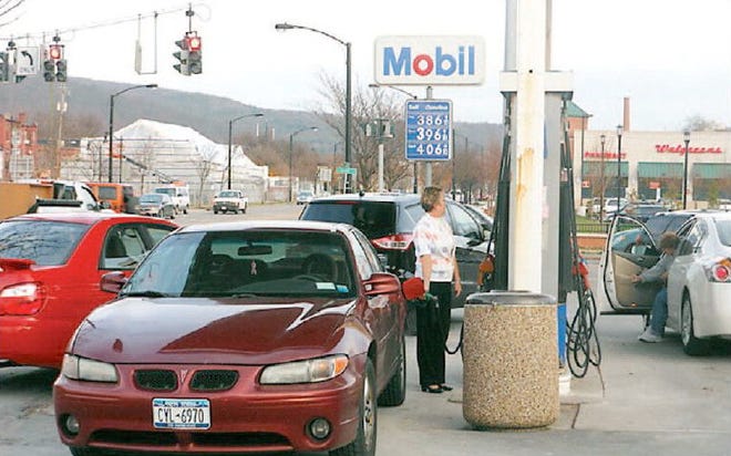 Jill Malone, of Pine City, said she is glad to see gas prices dropping as she fills her car’s tank Tuesday afternoon at the 7-Eleven on Denison Parkway.