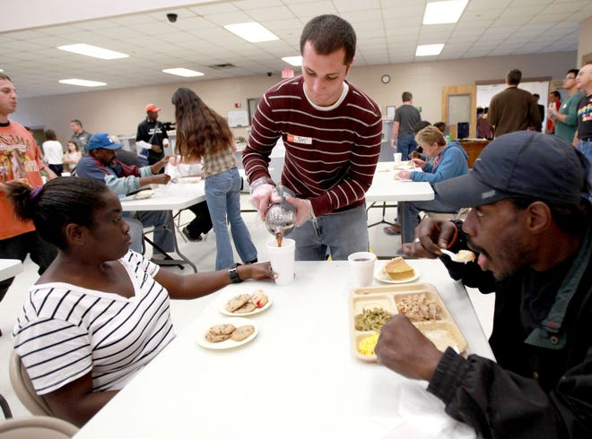 Volunteers serve Thanksgiving dinner at the St. Francis House, in Gainesville.
