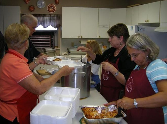 Church members, shown here during last year's event, will be dishing out a Thanksgiving meal again today.