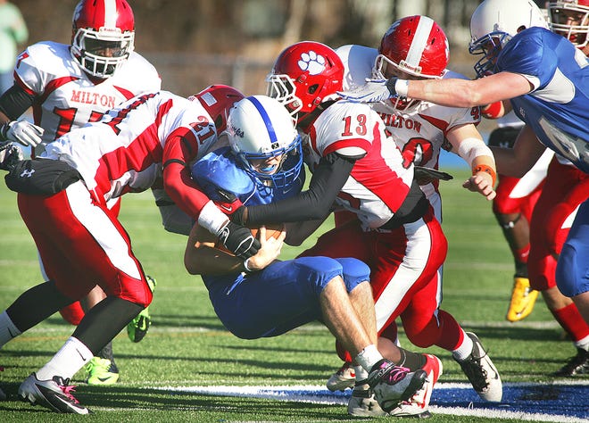 Milton's Leroy Goodman and Chavinskee Milcent put down Braintree QB Anthony Luisi. Braintree hosted Milton in the Thanksgiving Day football rivalry, Thursday, Nov. 22, 2012.