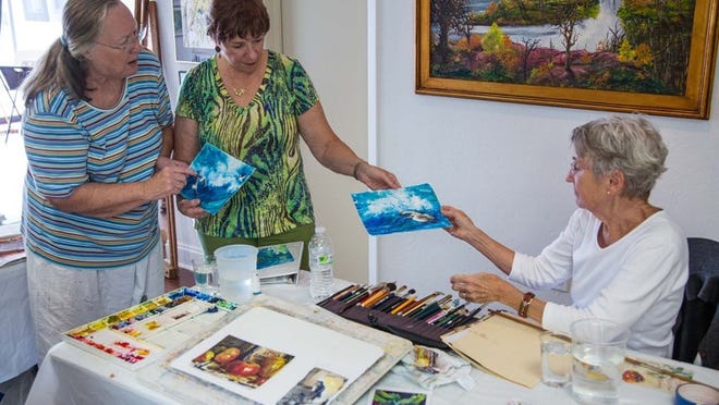 LAKE WORTH - Students Charline Nakamura (left), of Lake Worth, and Phyllis Barnes (center), of South Palm Beach, discuss techniques with instructor Joan Tiberi, of Lantana, during a watercolor class at the Lake Worth Art League gallery. Thomas Cordy/The Palm Beach Post