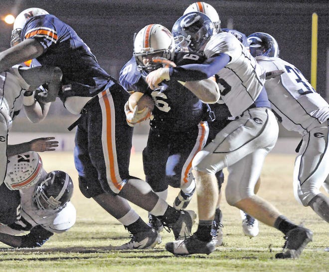 Photo courtesy of the Macon Telegraph Effingham County defenders close on a Northside Warner Robins running back on Friday.