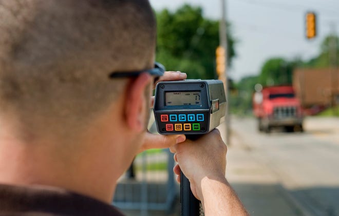 A speed of 17 miles-per-hour displays on a radar device held by Bartonville police officer Justin Egan.