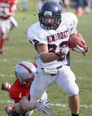 Pembroke's Colin Claflin drives for a first down despite the attention of a Silver Lake opponent during the Thanksgiving Day game at Silver Lake Regional High School on Thursday, Nov. 22, 2012.