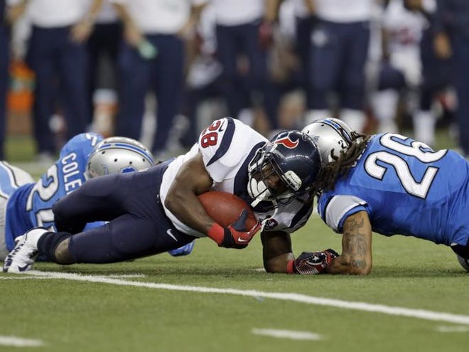Houston Texans running back Justin Forsett (28) is hit by Detroit Lions free safety Louis Delmas (26) during the third quarter of an NFL football game at Ford Field in Detroit, Thursday, Nov. 22, 2012. Forsett scored an 81-yard touchdown run on the play.