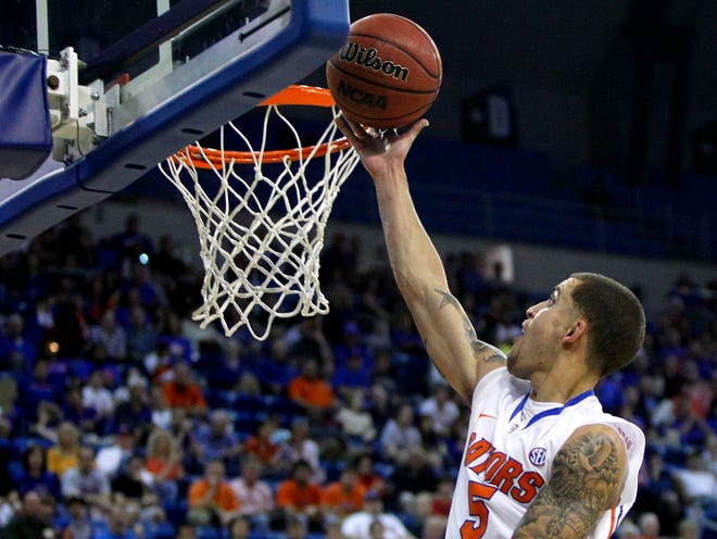 Florida's Scottie Wilbekin lays the ball into the basket during the first half against the UCF Knights at the O'Connell Center in Gainesville on Friday.