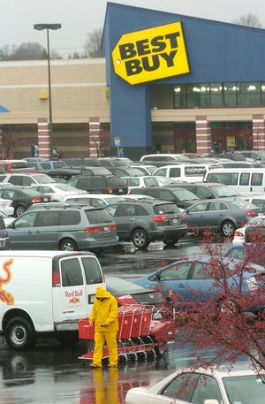 A Target employee at the Liberty Tree Mall in Danvers rounds up shopping carts in a crowded parking lot on "Black Friday," Nov. 27, 2009, the day after Thanksgiving known for shopping deals.