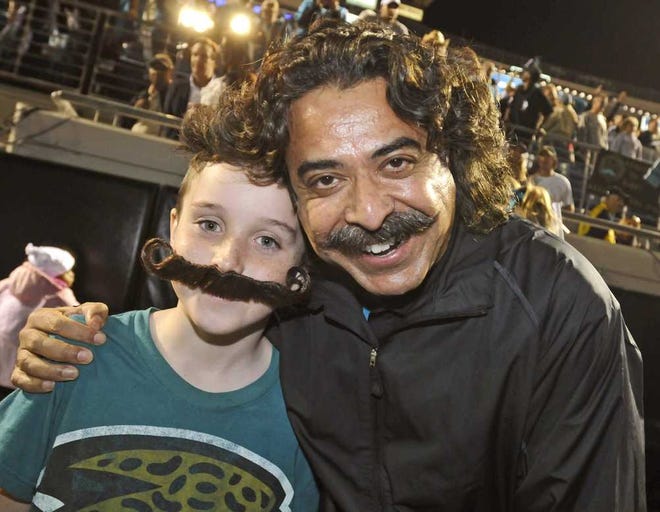 Will.Dickey@jacksonville.com Zachary Cronn, 10, had his photo taken with Jaguars owner Shad Khan after winning a mustache contest at a rally in January.