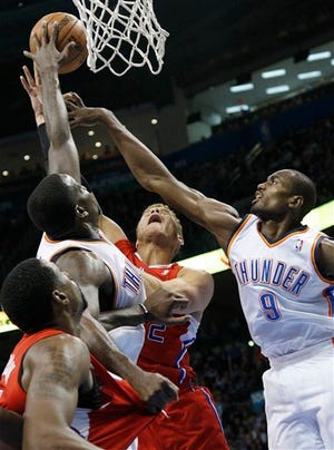 Los Angeles Clippers forward Blake Griffin, center, has his shot blocked by Oklahoma City Thunder center Kendrick Perkins. Perkins made his return to TD Garden Friday night.