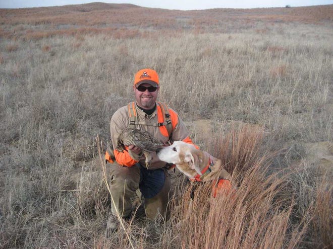 Chris Tymeson, an avid upland bird hunter and Topekan, proudly displays a lesser prairie chicken he bagged on a hunt in southwest Kansas. The U.S. Fish & Wildlife Service will release a ruling by the end of the month that will recommend lesser prairie chickens be listed as threatened, endangered or not warranted for listing.