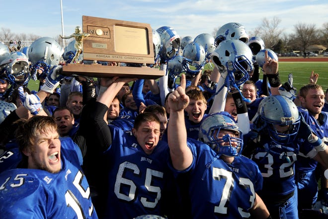 The Holton Wildcats celebrate their 21-0 win against Eudora in the class 4A state football championship on Saturday at Salina Stadium.