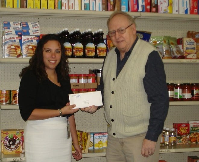Melinda Stumpf, regional community relations director for PPL, presents a $1,000 check to Ted von Mechow, president of Pennridge FISH Organization Inc. Pennridge FISH is a nonprofit organization that offers food, clothing and emergency financial assistance, as well as Christmas gifts and school supplies, to children and families in need who are living in the Pennridge School District.