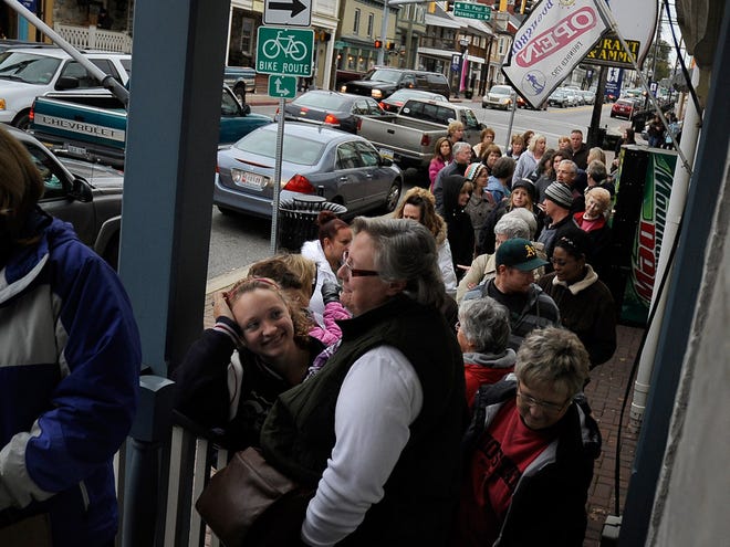 Fans wait in line to have books signed by romance queen Nora Roberts on Nov. 3 at Turn the Page, the bookstore she owns in her hometown, Boonsboro, Md. She also owns several other businesses in Boonsboro and has written books set in the town.