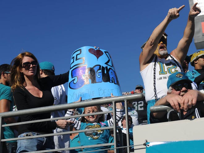 Krista Wilson and her daughter Riley Rumble, 5, show their support for the Jags in the third quarter on Sunday.