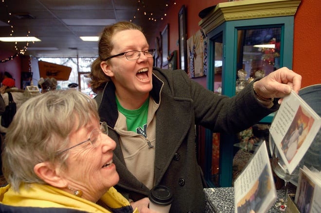 Angela Weck, of Edwards, laughs as she shows her mother-in-law Geri Weck, of Humboldt, Iowa, a card at The Main Statement in Peoria on Saturday. It was Small Business Saturday, and many small, local businesses tried to offer an alternative to bigger stores for local Thanksgiving weekend shoppers. The Main Statement, which sells gifts and accessories made by local artists, was a popular destination.