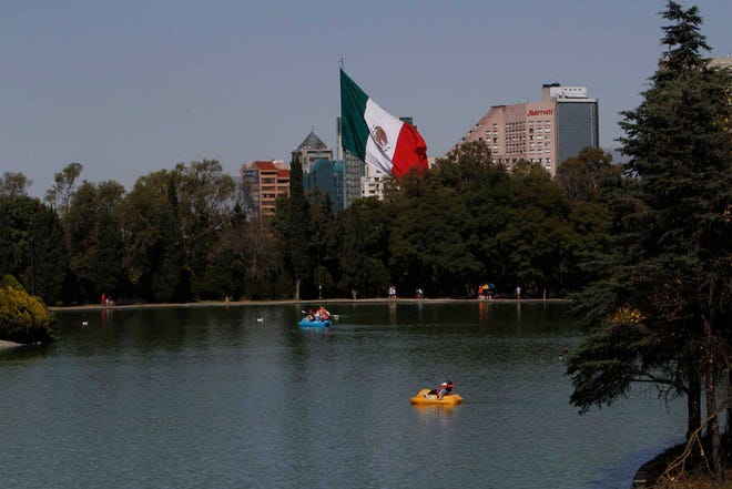 Paddle boaters make their way around a lake in the Chapultepec Park in Mexico City on Nov. 19. Chapultepec is a park divided between shady stretches of forest and more-developed plazas, fountains and sculpture gardens. On weekends, the northern end is crammed with vendors, entertainers and families out for the day.