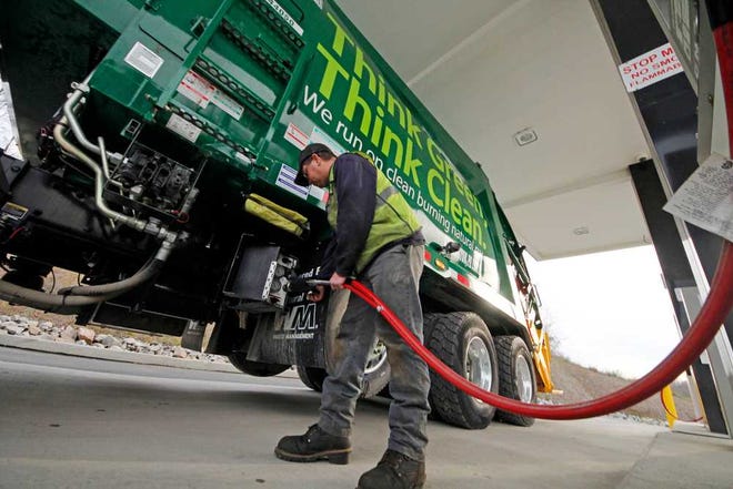 Waste Management driver Alan Sadler fills his truck Nov. 19 with CNG gas at the company's filling station in Washington, Pa. Years from now, motorists needing a fill-up might see natural gas pumps sharing space at the neighborhood filling station with ones dispensing gasoline and diesel.